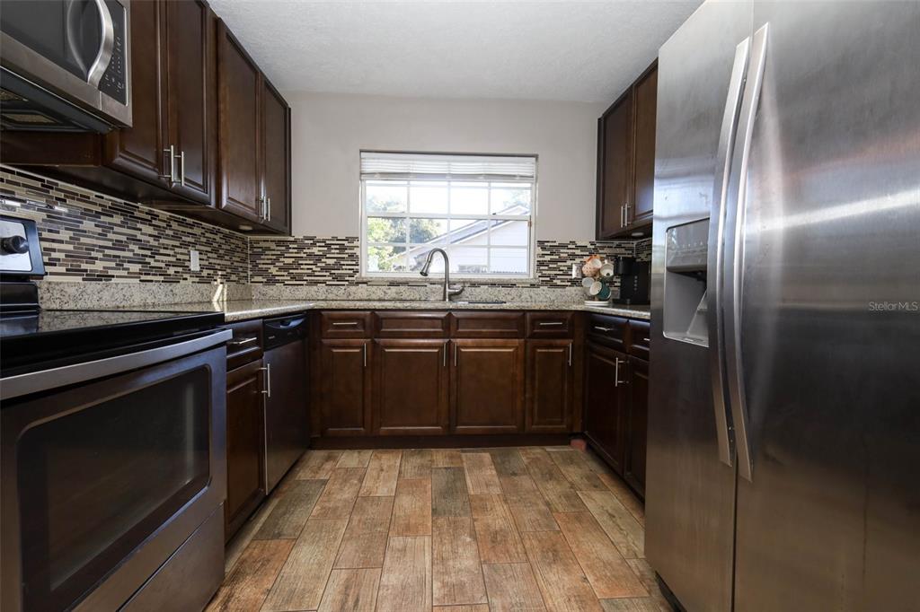 1531 Lawndale Circle Winter Park, FL 32792 - Photo 13 of 44 a kitchen with a sink stove and refrigerator