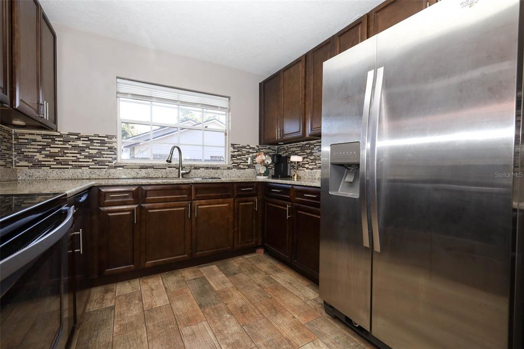 1531 Lawndale Circle Winter Park, FL 32792 - Photo 14 of 44 a kitchen with a sink stove and refrigerator