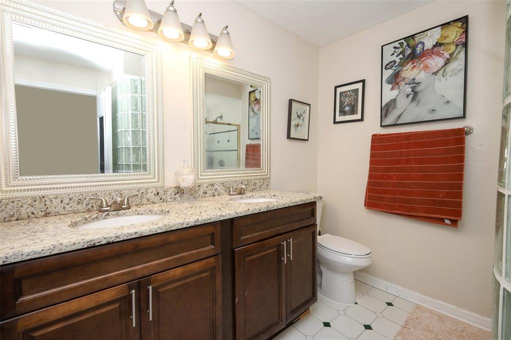 1531 Lawndale Circle Winter Park, FL 32792 - Photo 21 of 44 a bathroom with a granite countertop sink mirror and toilet