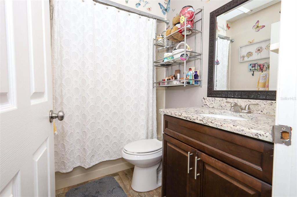1531 Lawndale Circle Winter Park, FL 32792 - Photo 25 of 44 a bathroom with a granite countertop sink toilet and shower