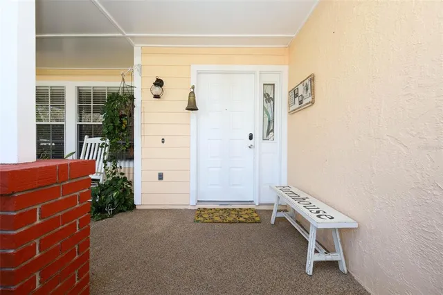 a view of hallway with furniture and a window