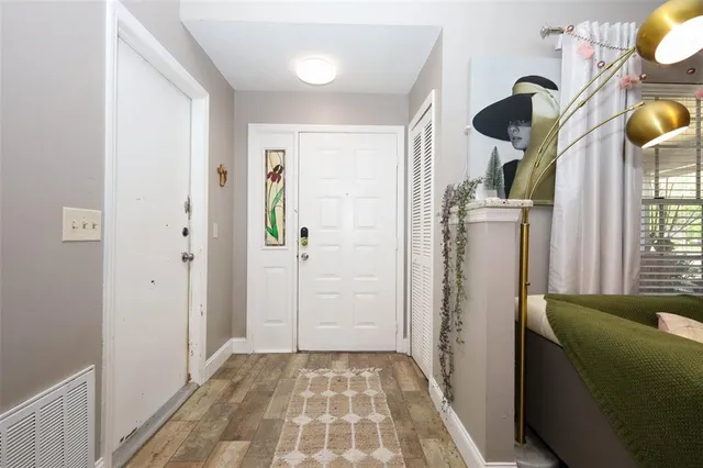 a living room with furniture a flat screen tv and a window