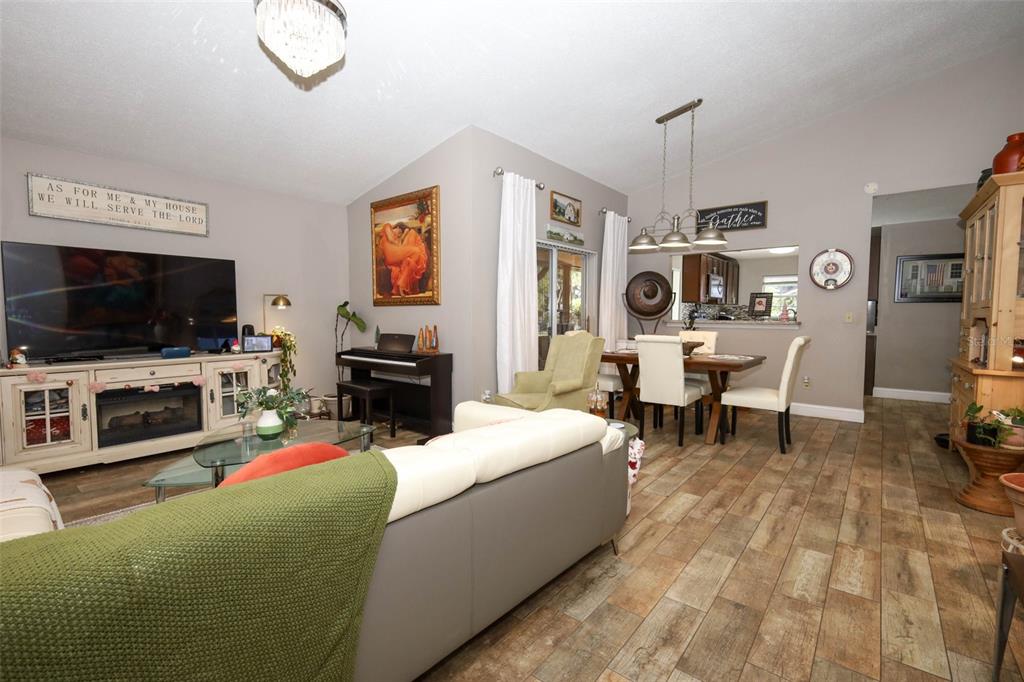 1531 Lawndale Circle Winter Park, FL 32792 - Photo 9 of 44 a living room with furniture a flat screen tv and a fireplace