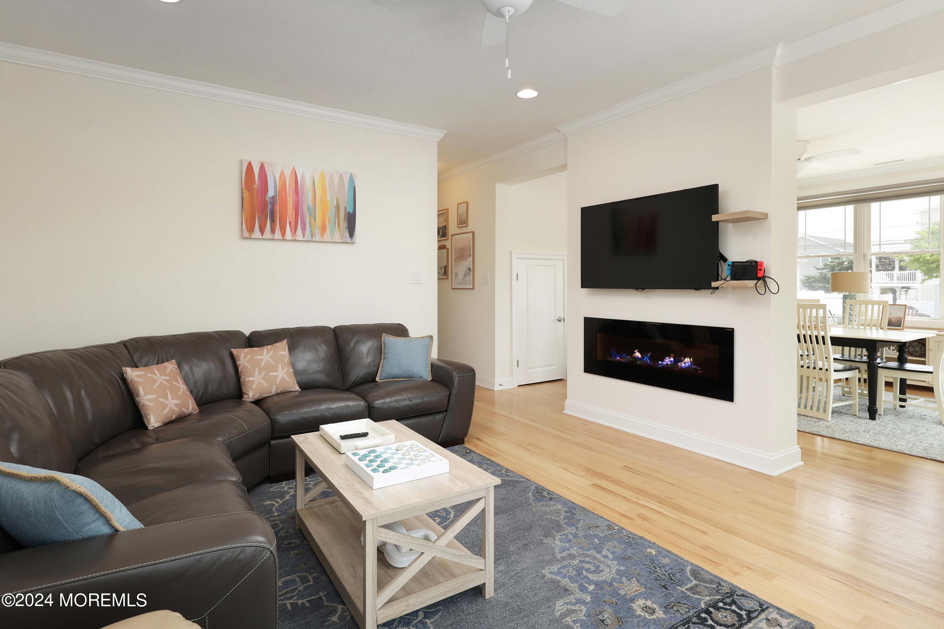 1607 Baltimore Avenue Lavallette, NJ 08735 - Photo 12 of 28 a living room with furniture a flat screen tv and a fireplace