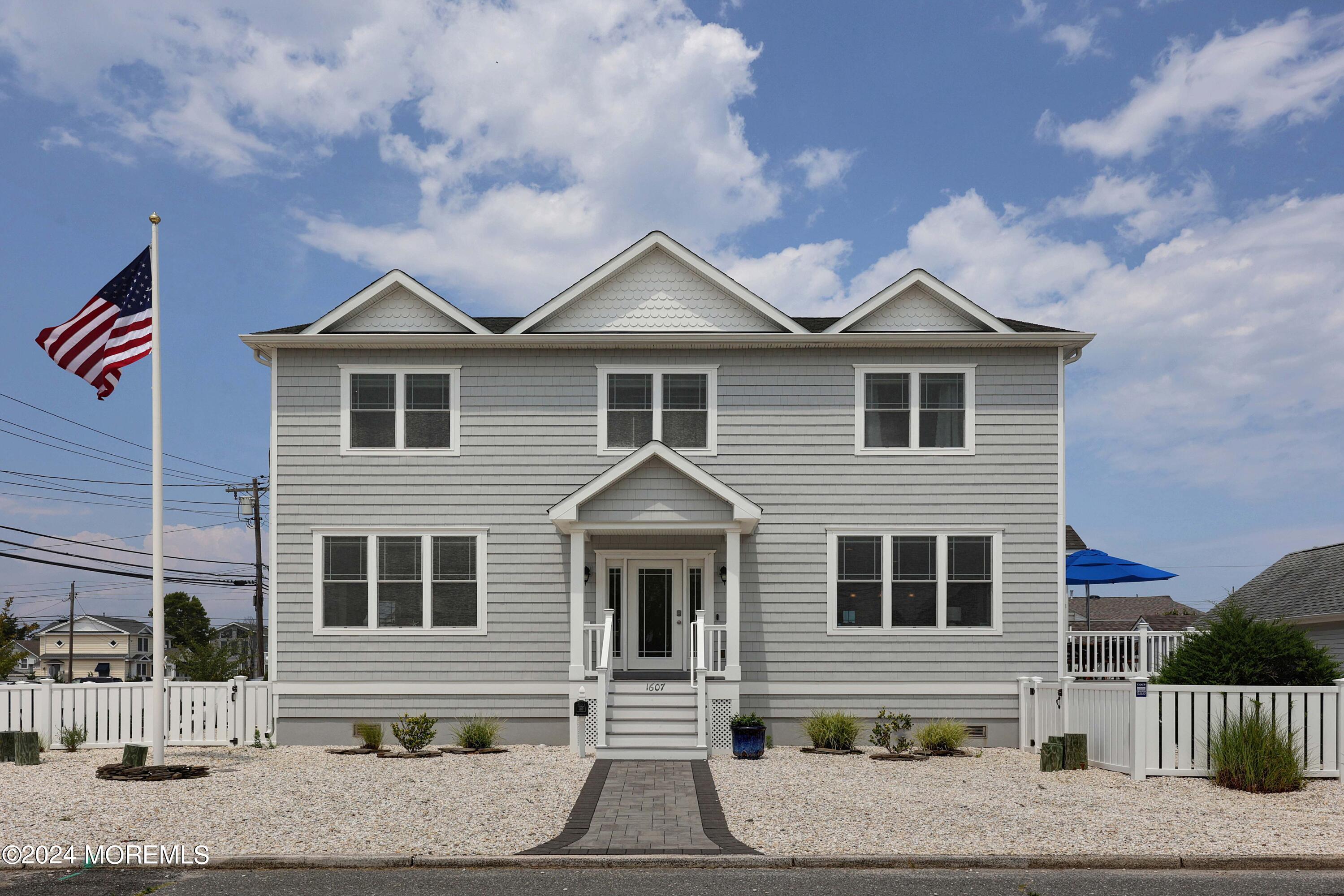 1607 Baltimore Avenue Lavallette, NJ 08735 - Photo 20 of 28 a front view of a house with a yard