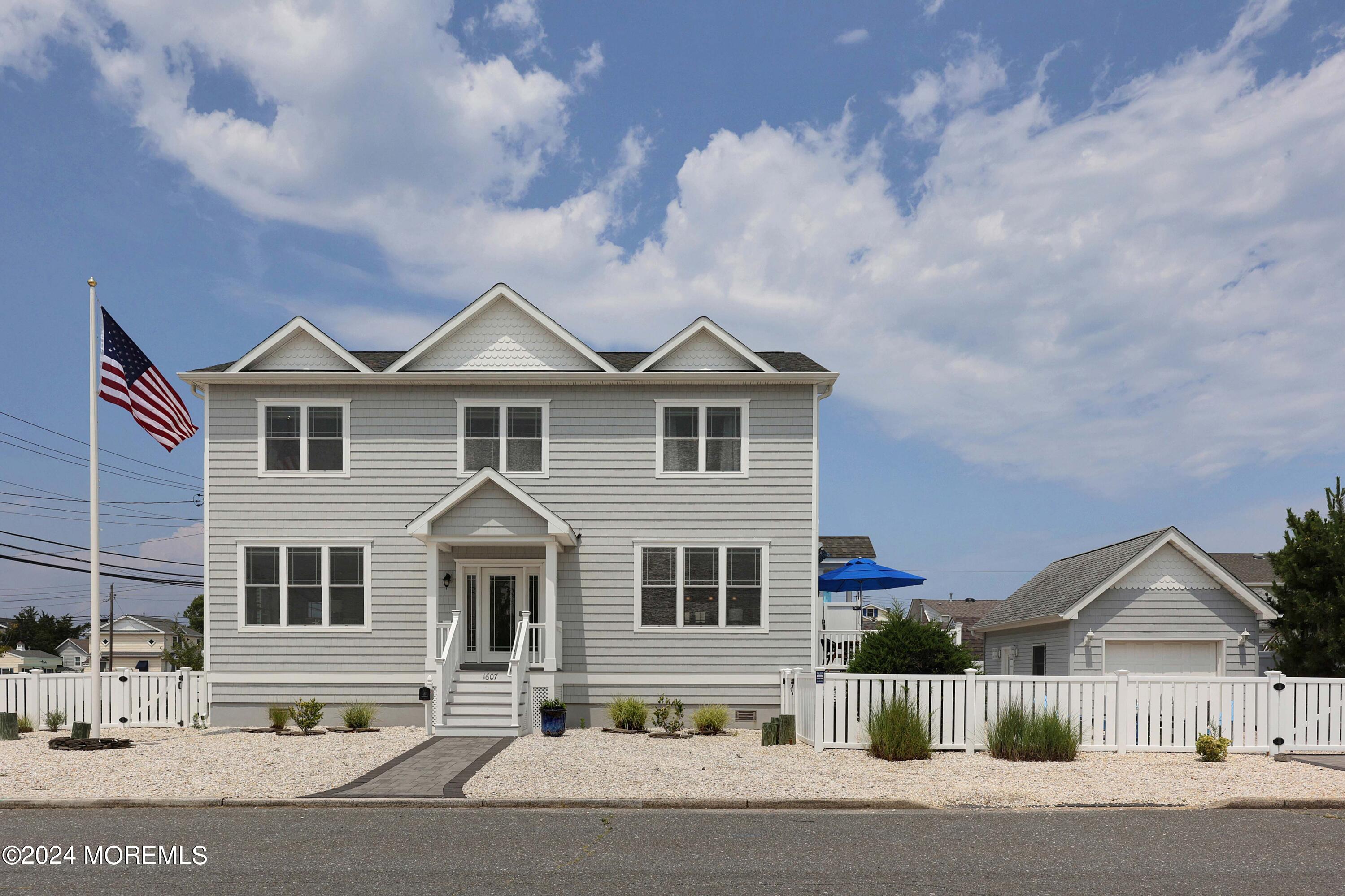 1607 Baltimore Avenue Lavallette, NJ 08735 - Photo 3 of 28 a front view of a house with a yard and garage