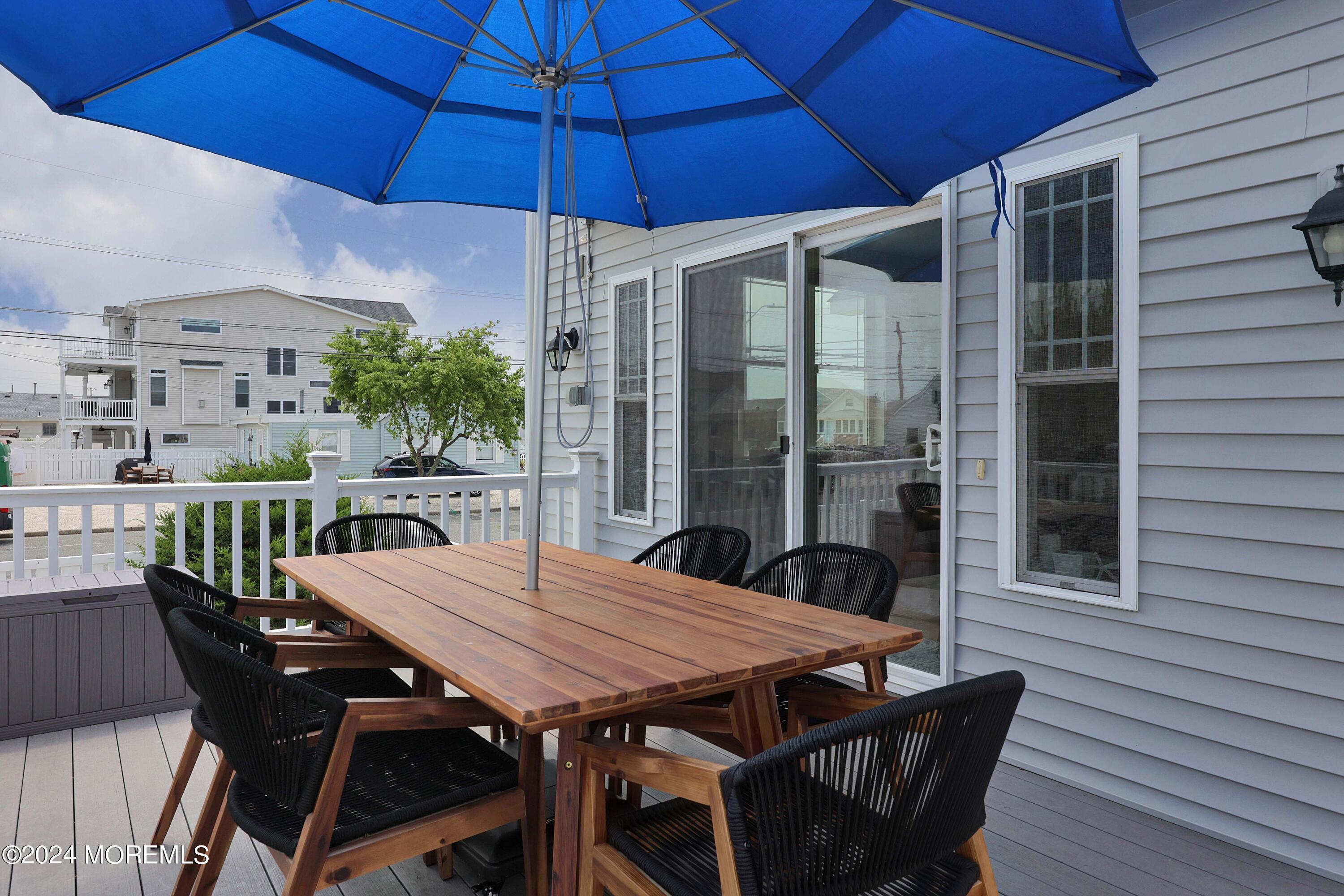 1607 Baltimore Avenue Lavallette, NJ 08735 - Photo 5 of 28 a view of a patio with table and chairs under an umbrella