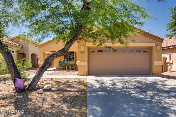 a view of a house with a tree