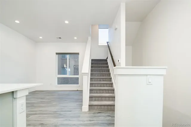 a view of entryway and hall with wooden floor