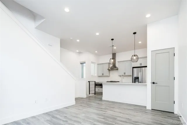 a view of kitchen with kitchen island and stainless steel appliances