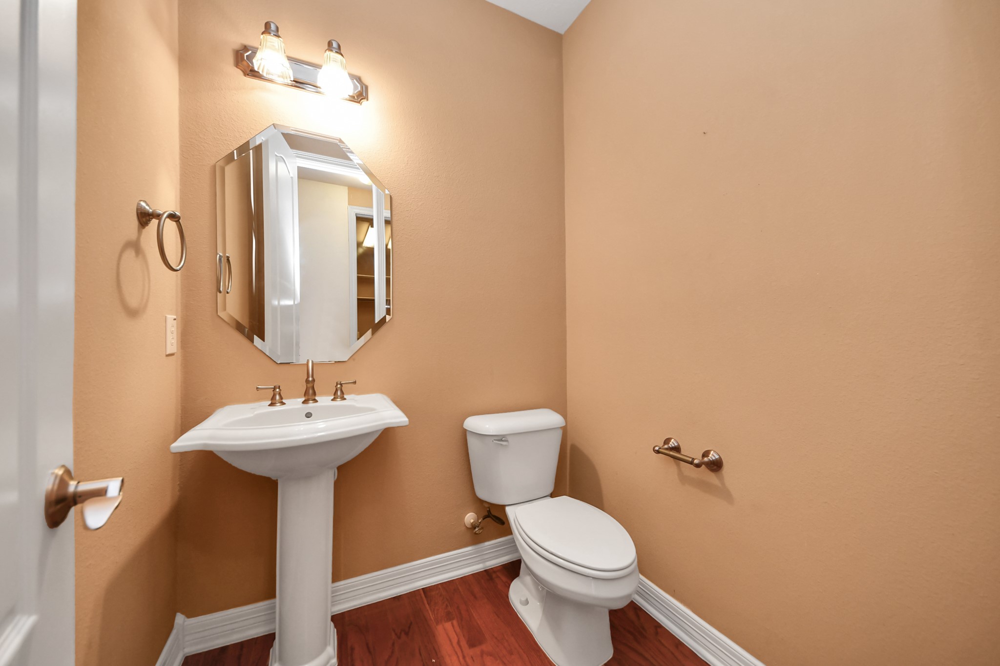 17618 Raven Canyon Lane Houston, TX 77095 - Photo 15 of 45 A well-maintained half bathroom featuring a pedestal sink and modern lighting.