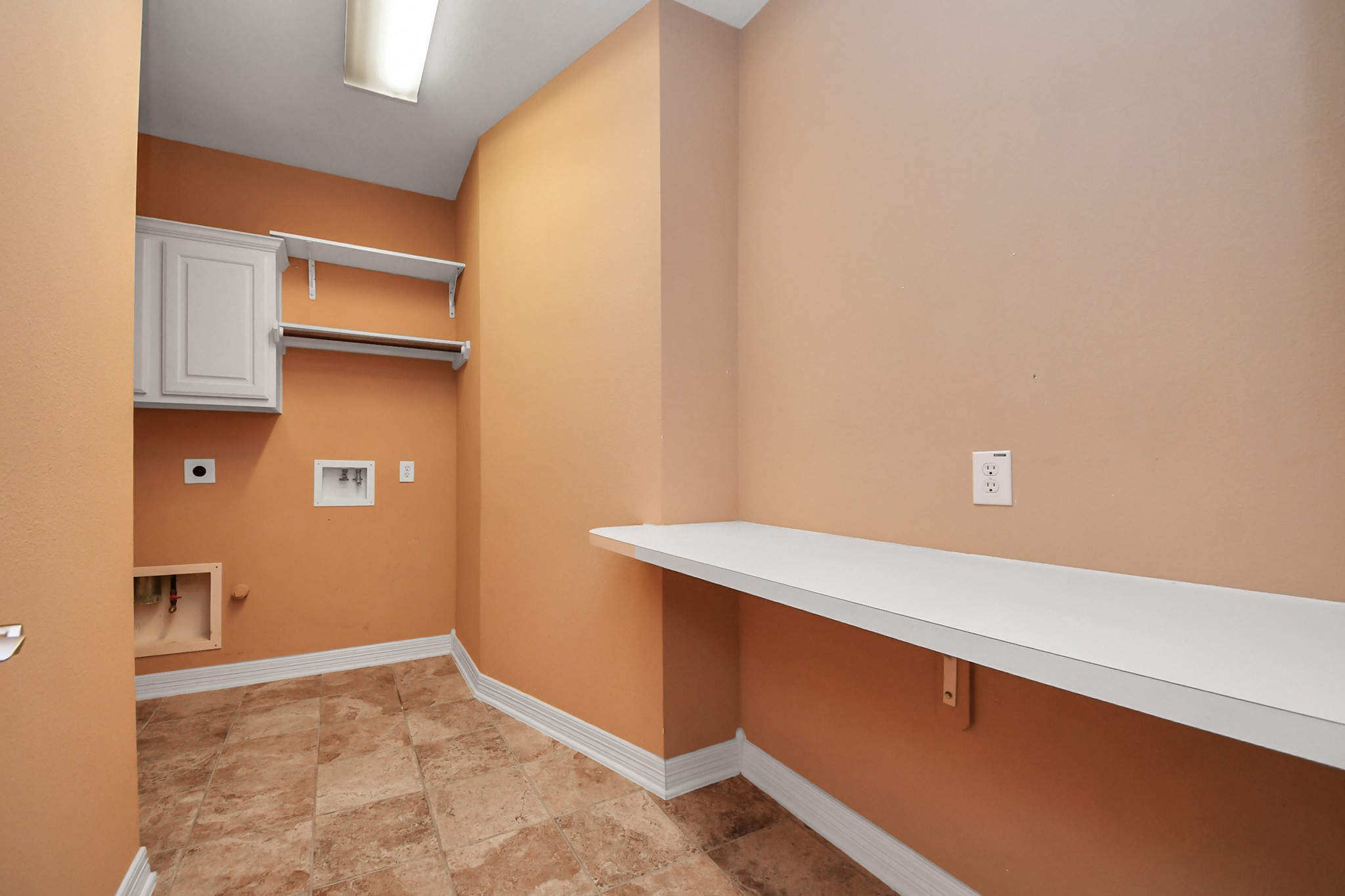 17618 Raven Canyon Lane Houston, TX 77095 - Photo 17 of 45 Spacious laundry room with plenty of storage, featuring built-in cabinets and a counter for folding clothes, plus washer and dryer hookups.
