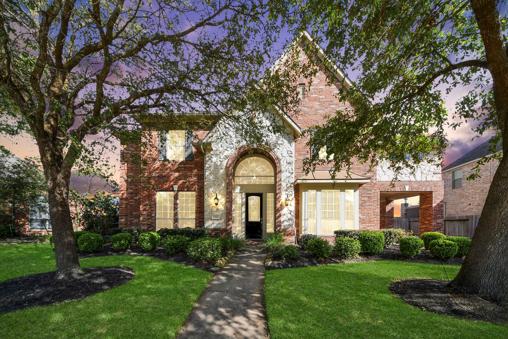 17618 Raven Canyon Lane Houston, TX 77095 - Photo 2 of 45 Front view of the home with lush greenery, perfectly manicured lawn, and charming trees, creating great curb appeal.