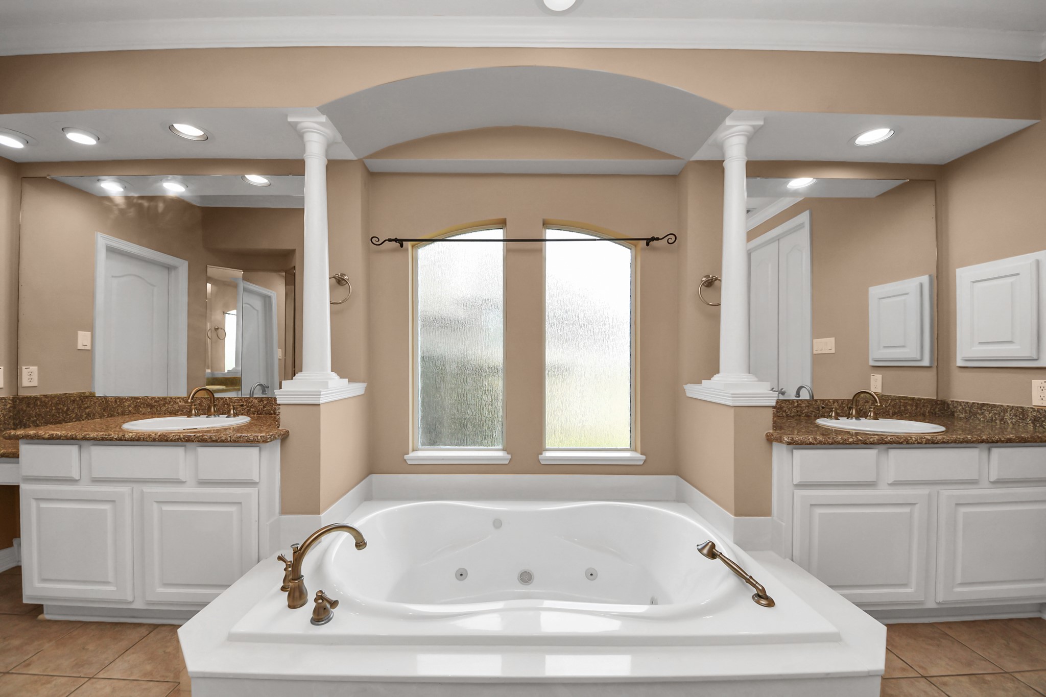 17618 Raven Canyon Lane Houston, TX 77095 - Photo 21 of 45 Spacious master bathroom with a relaxing soaking tub, separate dual vanities, and large mirrors that enhance the room's openness.