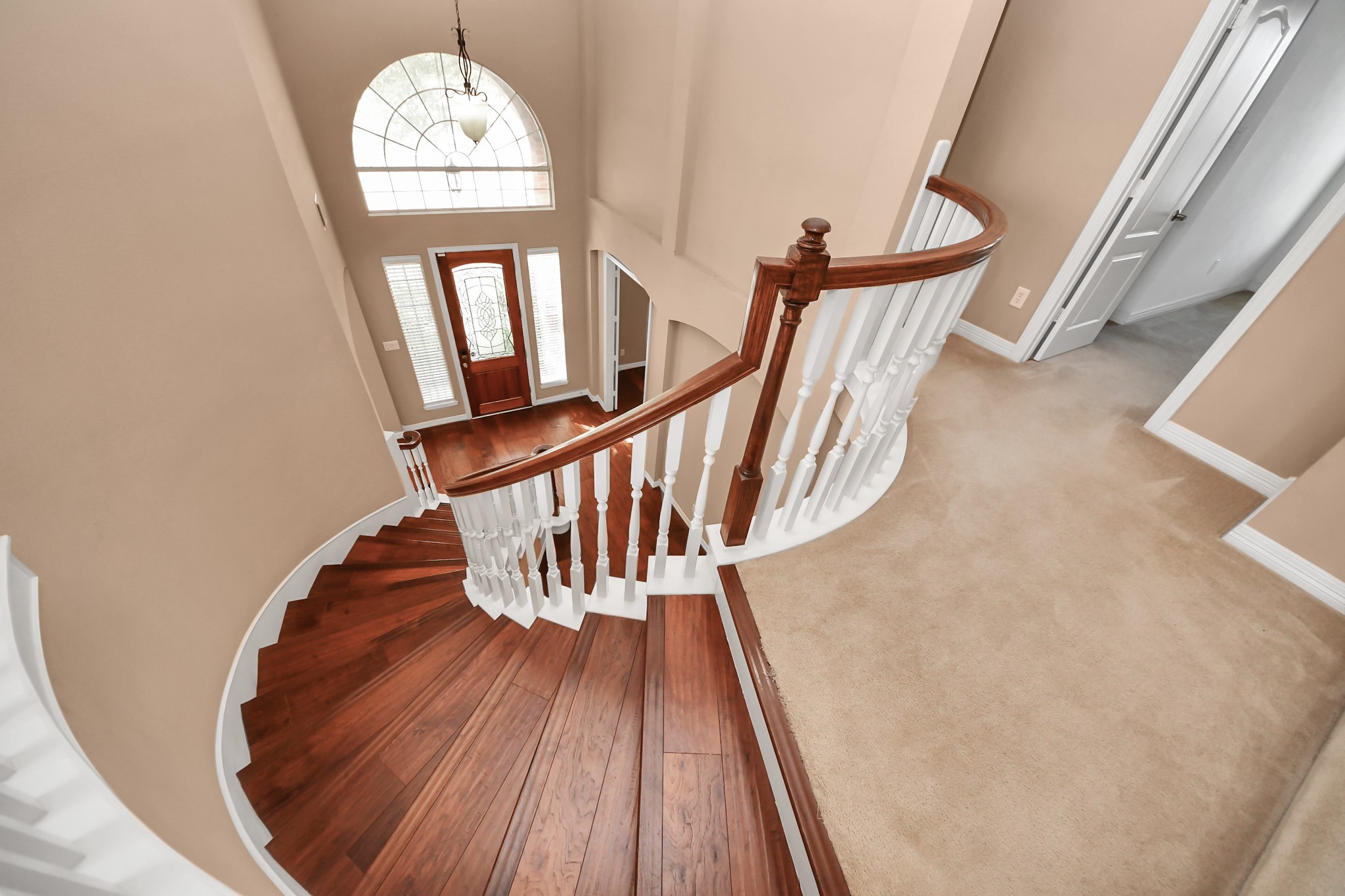 17618 Raven Canyon Lane Houston, TX 77095 - Photo 25 of 45 Gorgeous staircase with wood treads and a charming banister, providing a grand entrance with views of the main floor below.