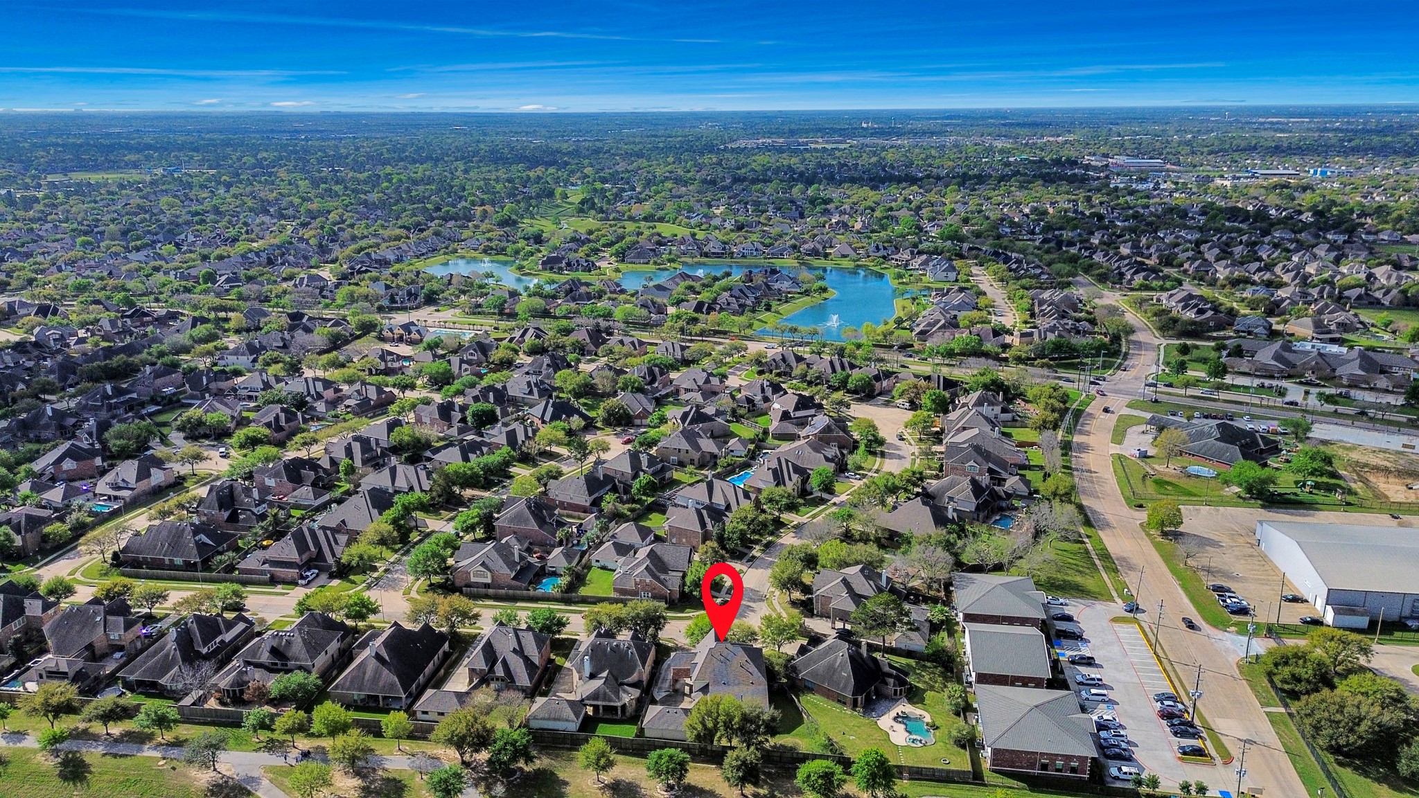 17618 Raven Canyon Lane Houston, TX 77095 - Photo 43 of 45 A stunning aerial view of the property located at 2704 Sunnyside, showcasing the peaceful neighborhood with beautiful green spaces and nearby lakes.