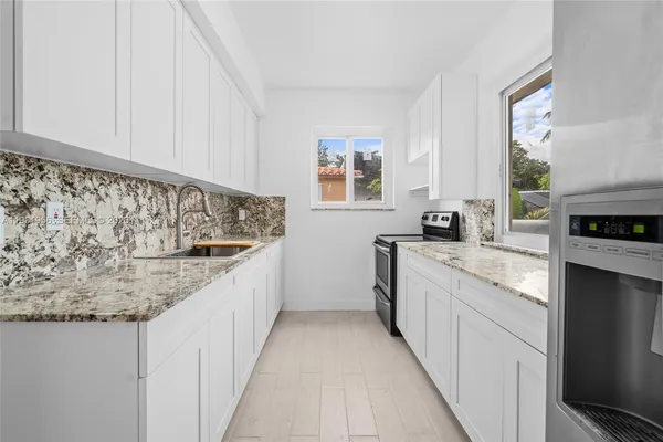 a kitchen with a sink and cabinets