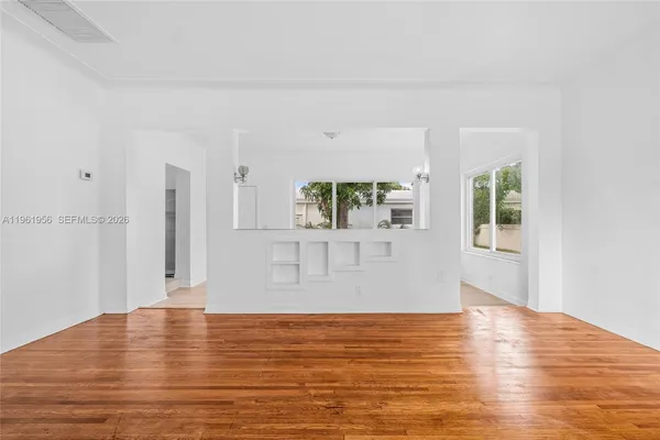 a view of empty room with wooden floor