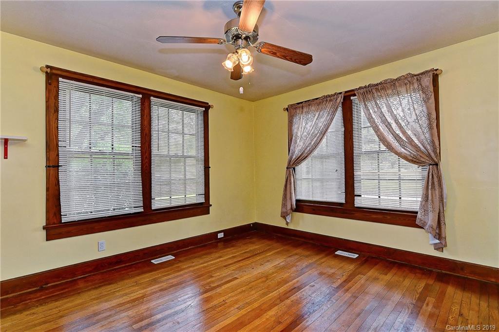 508 Ford Street Kannapolis, NC 28083 - Photo 7 of 13 a view of an empty room with wooden floor and a window