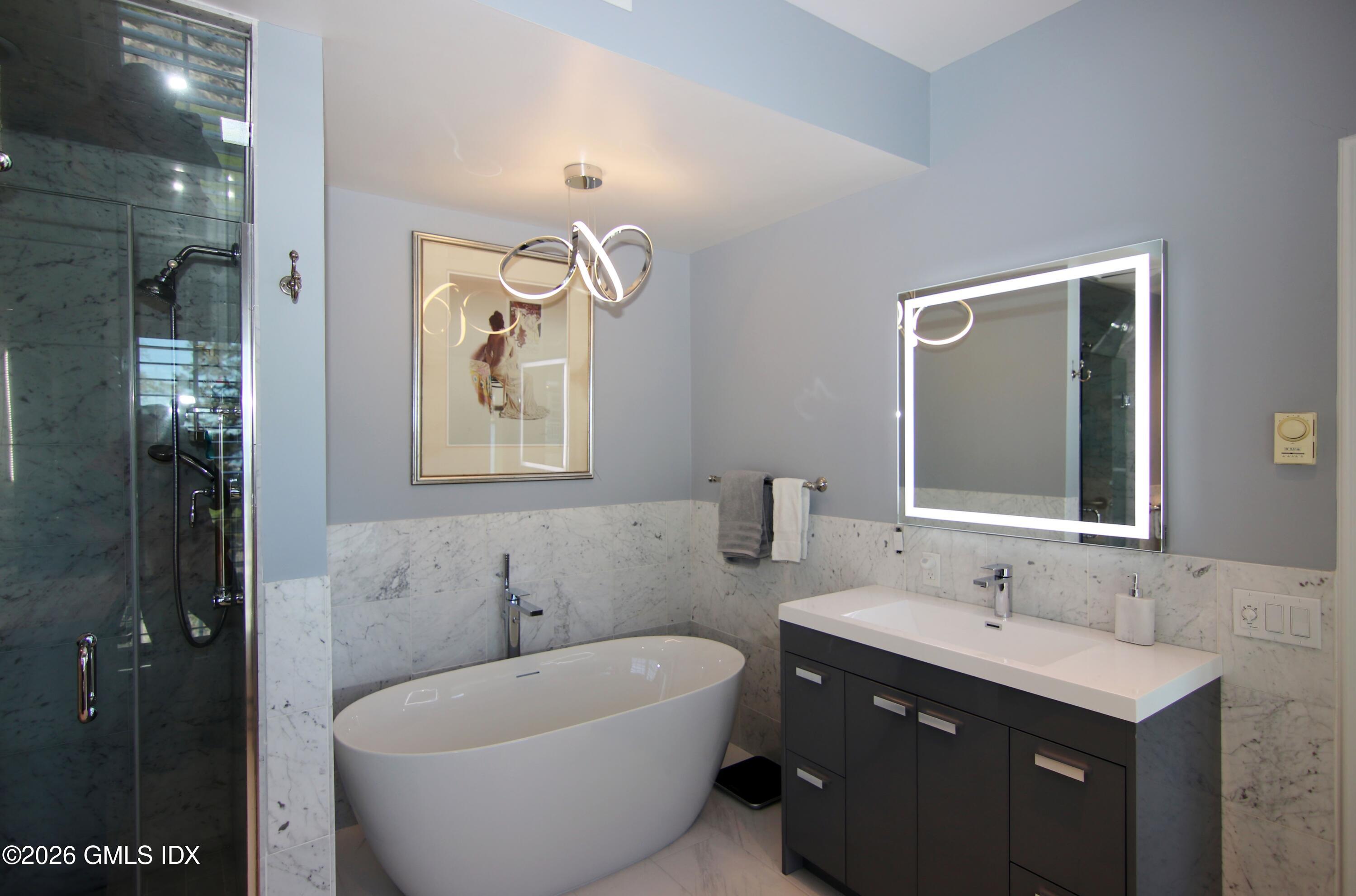 633 Steamboat Road, Unit 5 Greenwich, CT 06830 - Photo 26 of 29 a bathroom with a bathtub and double sink