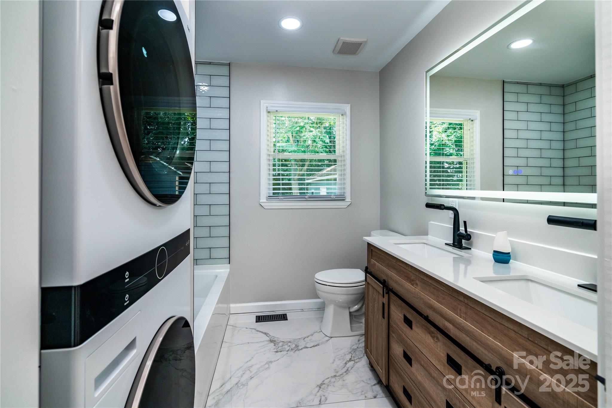 305 Linden Circle Gastonia, NC 28054 - Photo 18 of 37 a bathroom with a sink a toilet a vanity and mirror