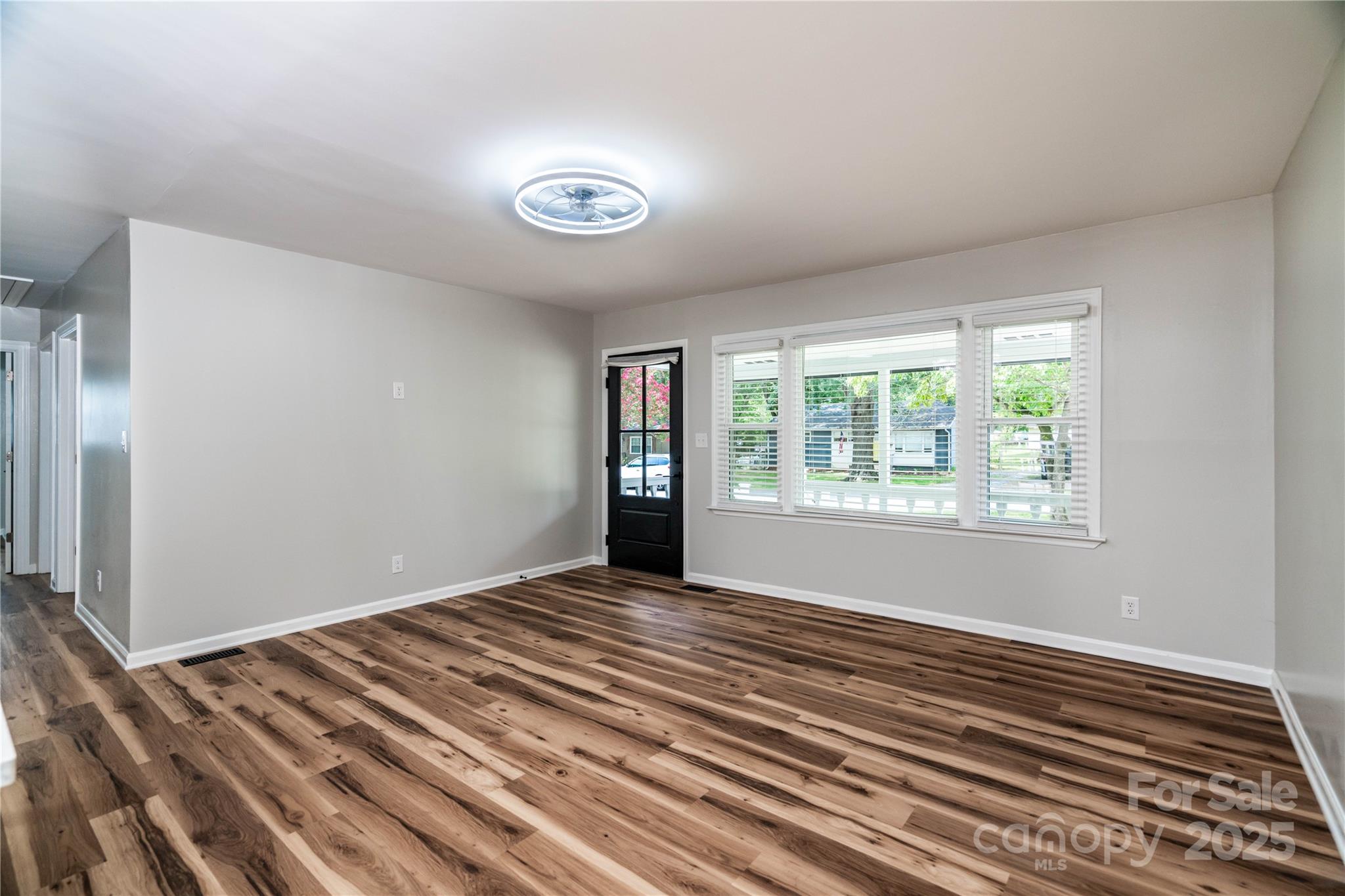 305 Linden Circle Gastonia, NC 28054 - Photo 2 of 37 a view of an empty room with wooden floor and a window