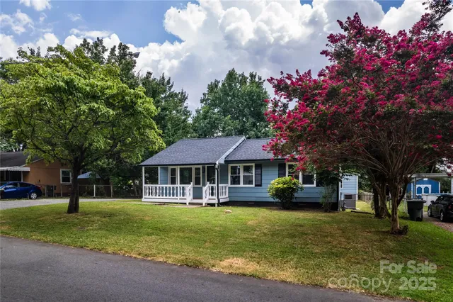 a house view with a sitting space and garden
