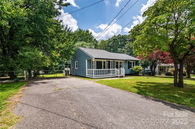a view of a backyard with large trees