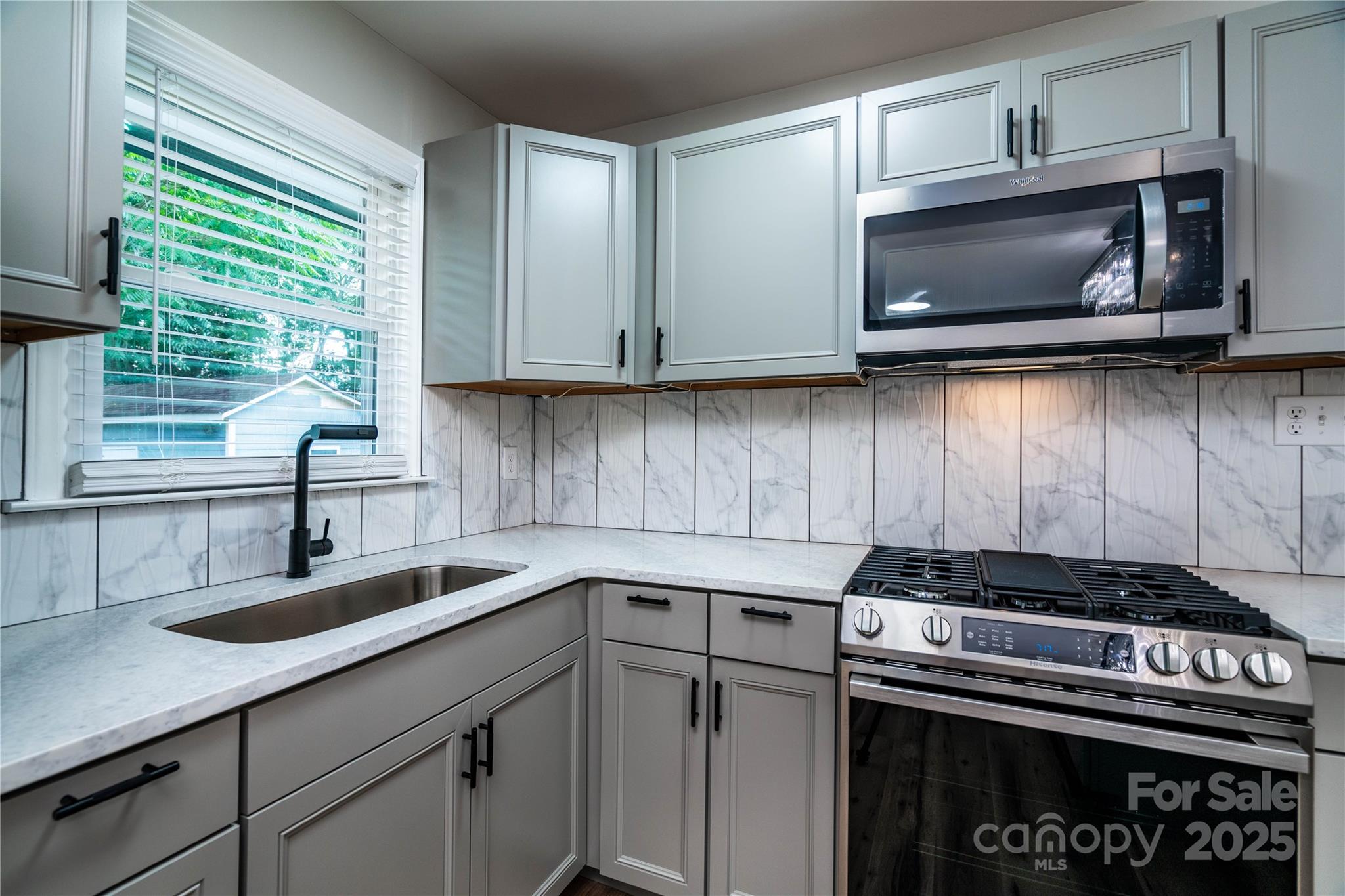 305 Linden Circle Gastonia, NC 28054 - Photo 4 of 37 a kitchen with granite countertop a stove sink and microwave