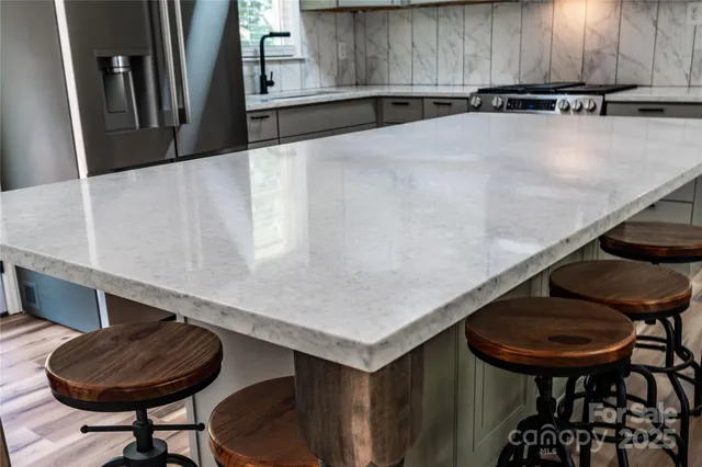 a kitchen with a table and chairs