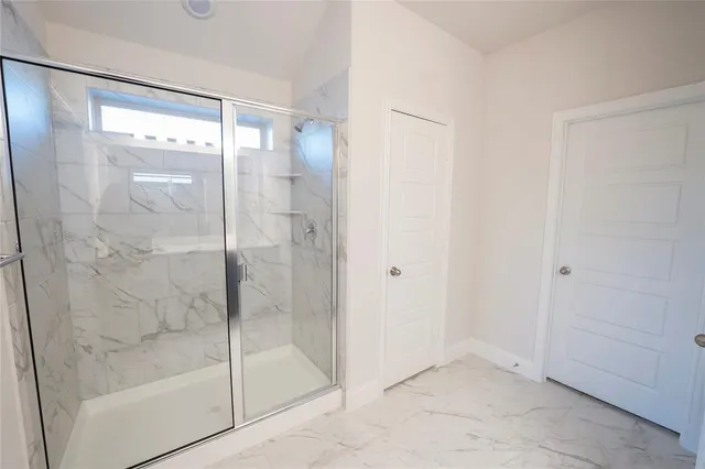 a bathroom with a glass shower door