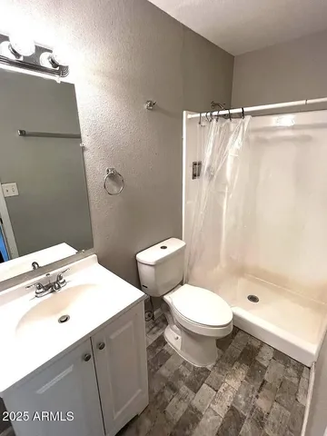 a bathroom with a sink toilet and shower