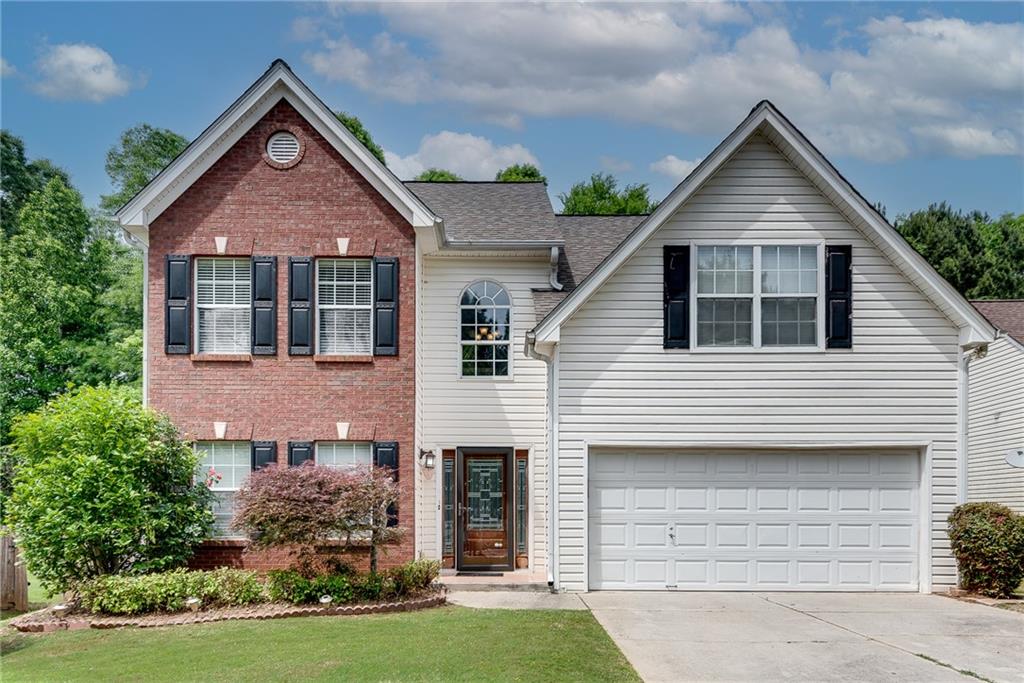 a front view of a house with a yard