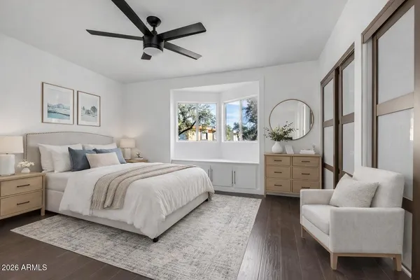 a spacious bedroom with a bed a couch and a window