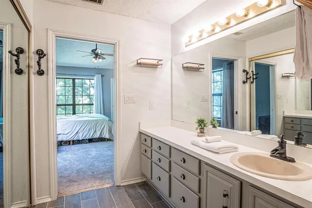 a en suite bathroom with a double vanity sink a mirror and a shower