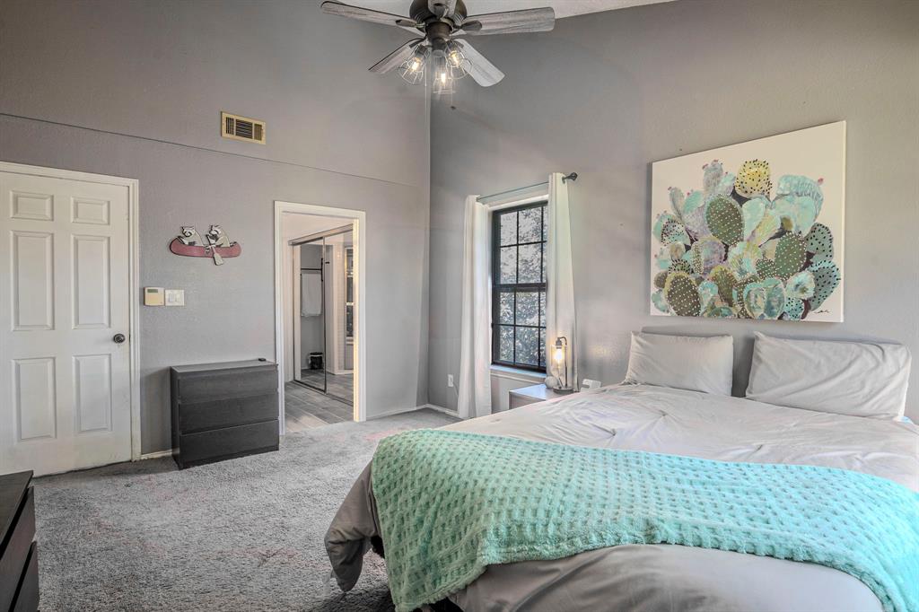 4516 Forestgate Drive Arlington, TX 76017 - Photo 2 of 23 a bedroom with a bed and a chandelier