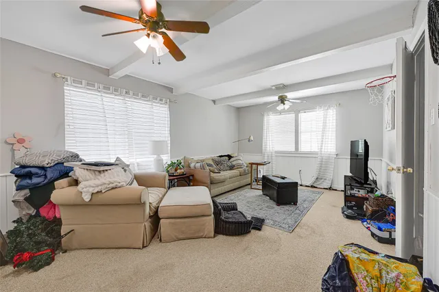 a room with furniture a chandelier and a window