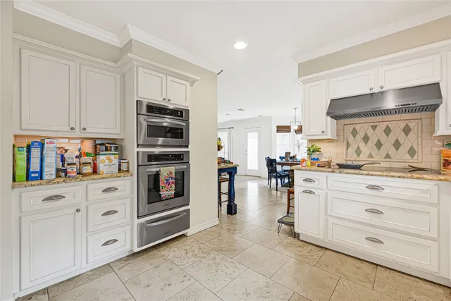 a kitchen with stainless steel appliances cabinets and a window