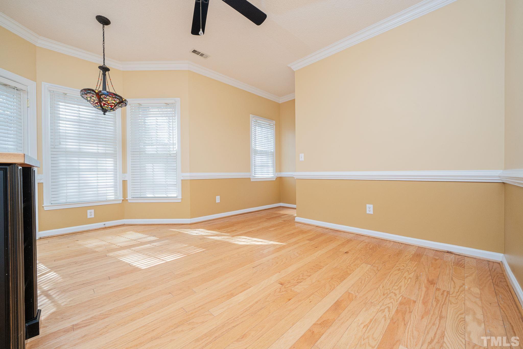 5305 Blakeley Lane Raleigh, NC 27613 - Photo 8 of 11 a view of an empty room with window and wooden floor