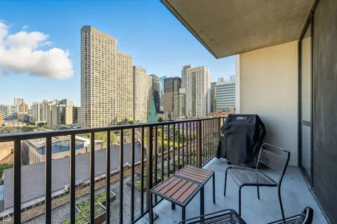 a view of a balcony with chair and iron stairs