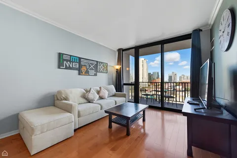 a living room with furniture and a floor to ceiling window