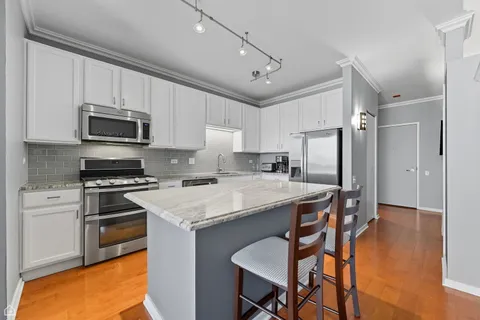 a kitchen with a stove a refrigerator and a microwave