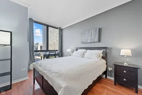 a bedroom with a bed and a night stand