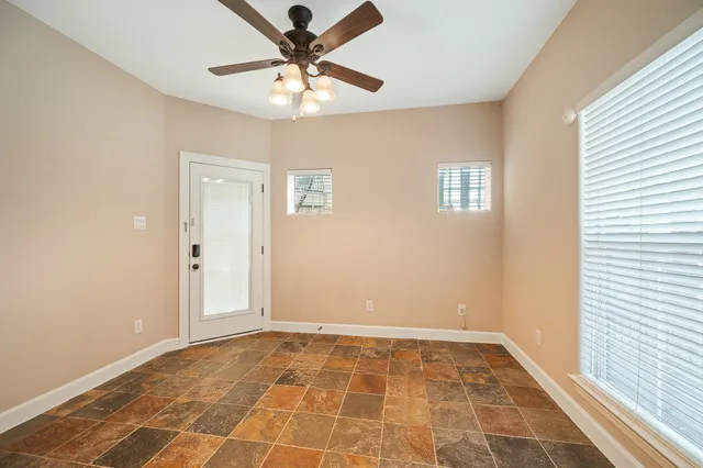 a view of a kitchen with wooden floor and a hallway