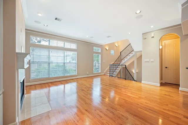 a large kitchen with granite countertop a sink and cabinets with wooden floor