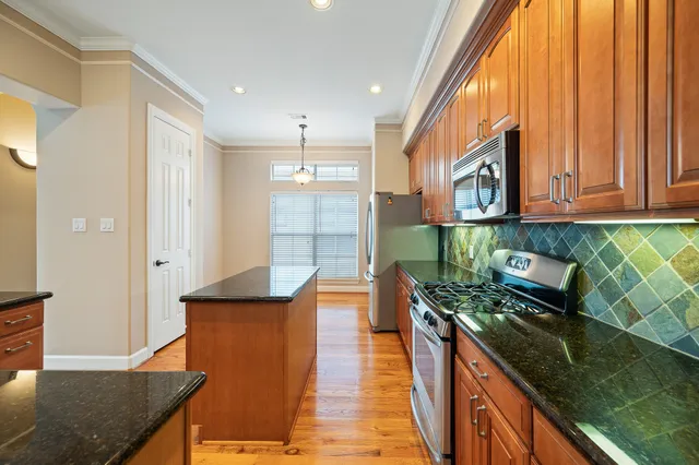 an empty room with closet and a chandelier fan