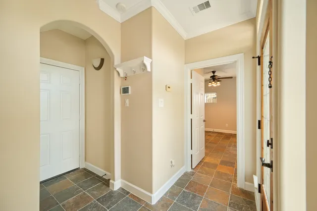a view of empty room with wooden floor and fireplace