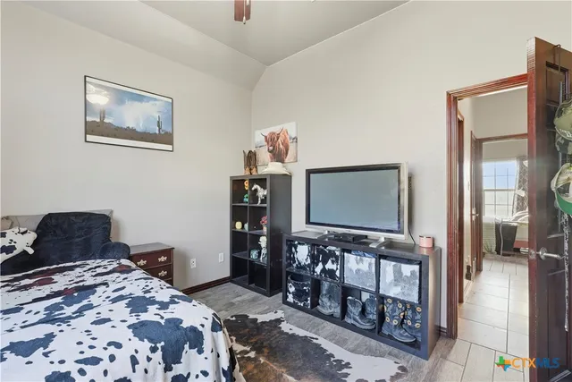 a bedroom with a bed and flat screen tv