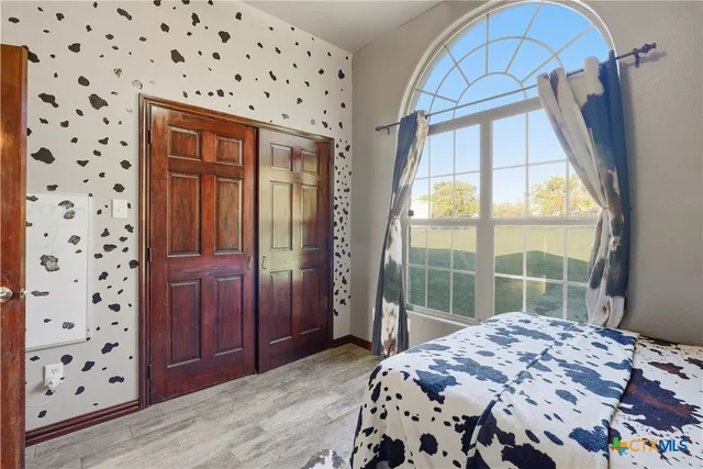 a bedroom with a bed and a window