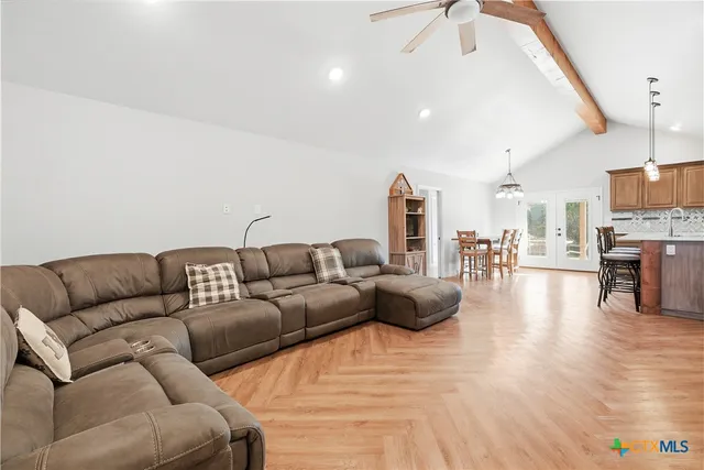 a living room with furniture and a wooden floor